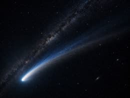 Comet with a long blue-white tail in deep space